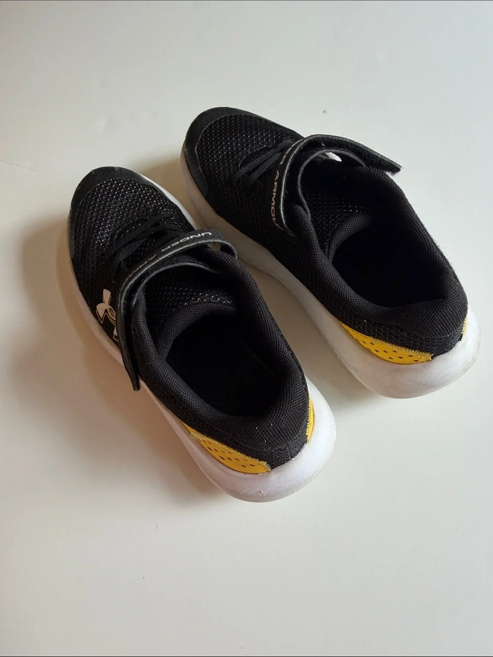 Under Armour Black and White Kids' Athletic Sneakers with Gold Logo